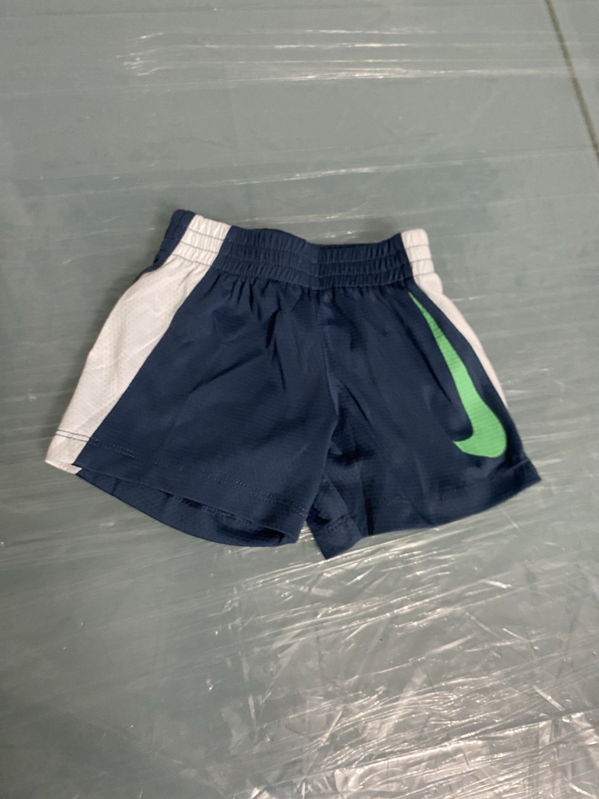 Nike shorts featuring a navy blue color with white side panels for Infants