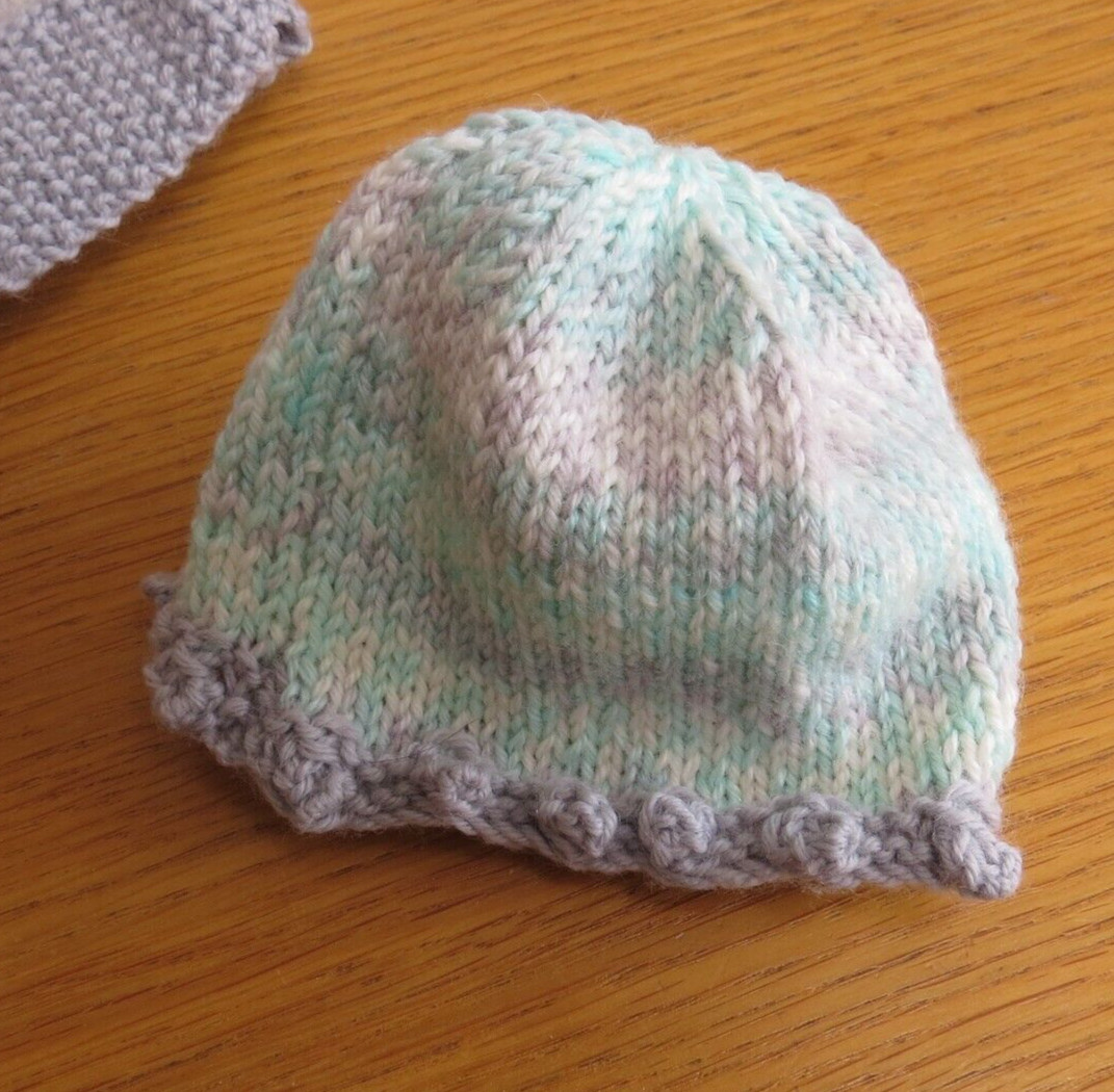 Baby girl’s pinafore, beanie and bootie set. Pastel green and grey. Hand knit