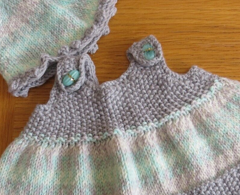 Baby girl’s pinafore, beanie and bootie set. Pastel green and grey. Hand knit